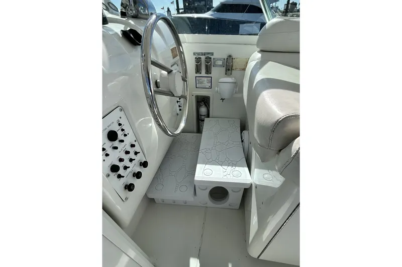 Slide: The Image of 1996 Hatteras 39 Sport Express helm with steering wheel and control panel. - 17