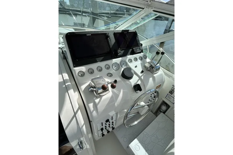 Slide: The Image of Helm of 1996 Hatteras 39 Sport Express with modern navigation equipment and controls. - 18