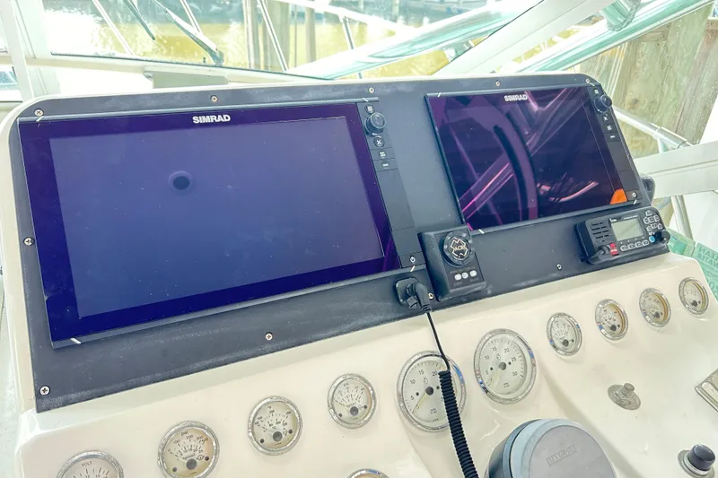 Slide: The Image of Control panel of a 1996 Hatteras 39 Sport Express with Simrad displays and gauges. - 19
