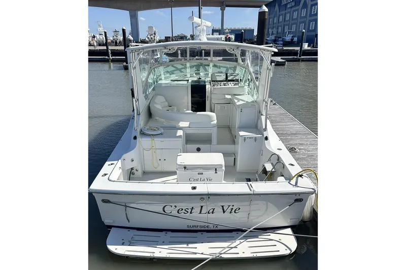 Slide: The Image of 1996 Hatteras 39 Sport Express boat docked, rear view, named "C'est La Vie," Surfside, TX. - 2