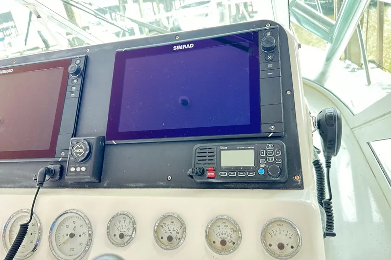 Slide: The Image of Control panel of a 1996 Hatteras 39 Sport Express with Simrad displays and gauges. - 20