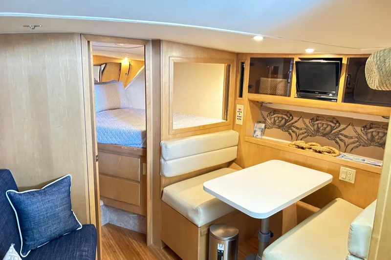Slide: The Image of Interior of 1996 Hatteras 39 Sport Express yacht with cozy seating and modern amenities. - 23