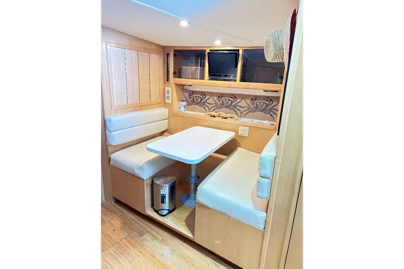 Slide: The Image of Interior of 1996 Hatteras 39 Sport Express with cozy dining area and built-in TV. - 24