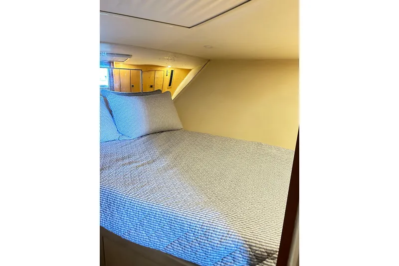 Slide: The Image of Cozy cabin interior of 1996 Hatteras 39 Sport Express with comfortable bedding. - 25