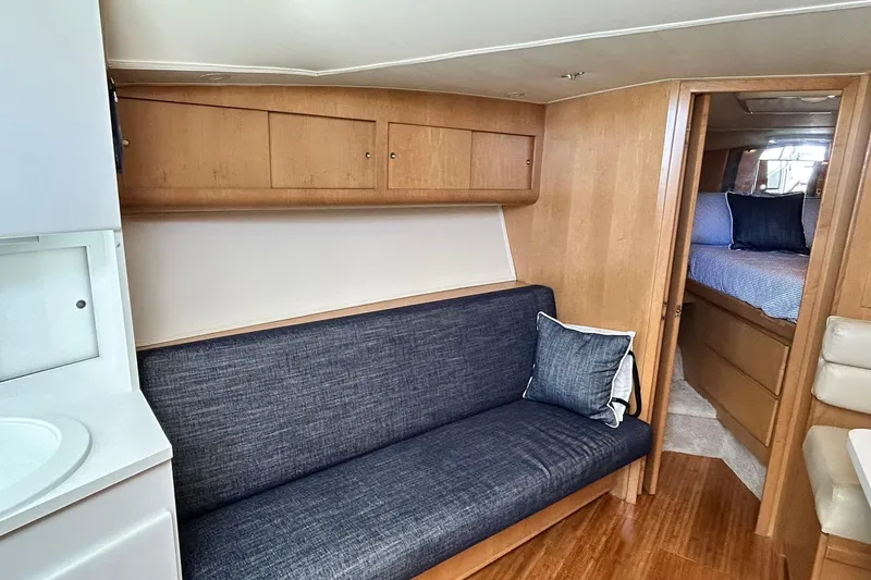 Slide: The Image of Interior of 1996 Hatteras 39 Sport Express yacht with cozy seating and wooden cabinetry. - 26