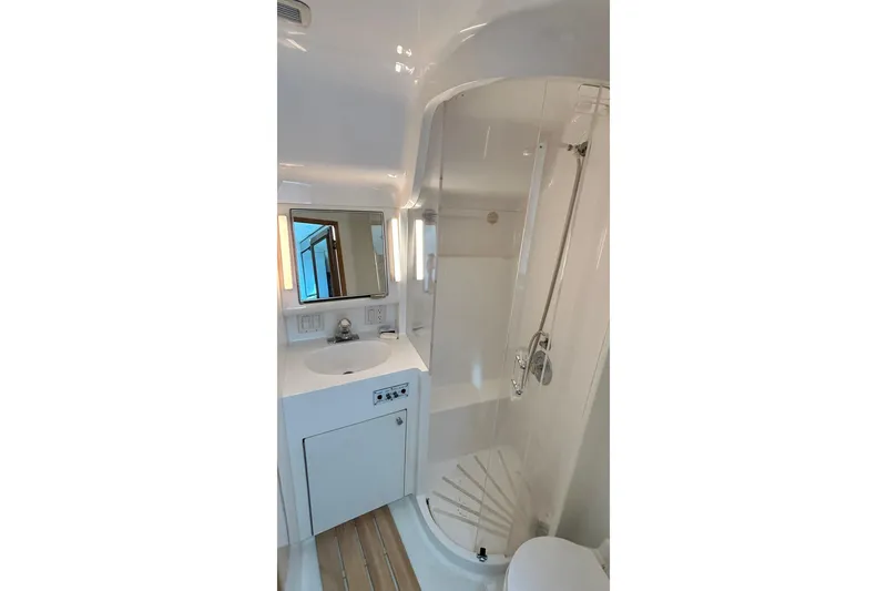 Slide: The Image of Bathroom interior of 1996 Hatteras 39 Sport Express yacht, featuring shower and vanity. - 27