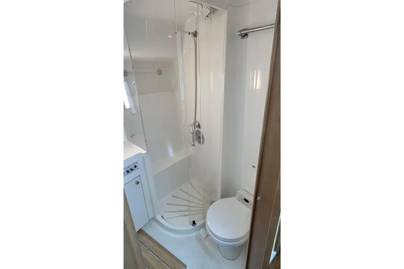 Slide: The Image of Bathroom interior of 1996 Hatteras 39 Sport Express yacht, featuring shower and toilet. - 28