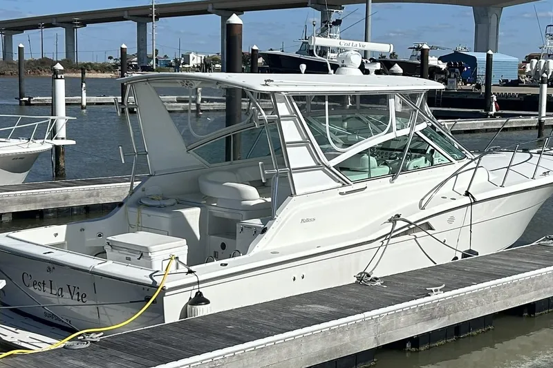 Slide: The Image of 1996 Hatteras 39 Sport Express yacht docked at marina, named "C'est La Vie." - 3