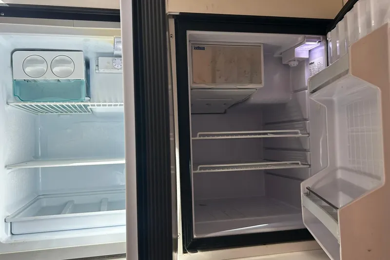 Slide: The Image of Empty refrigerator interior on a 1996 Hatteras 39 Sport Express boat. - 31