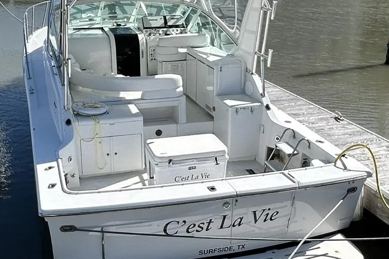 Slide: The Image of 1996 Hatteras 39 Sport Express boat named "C'est La Vie" docked at marina. - 4
