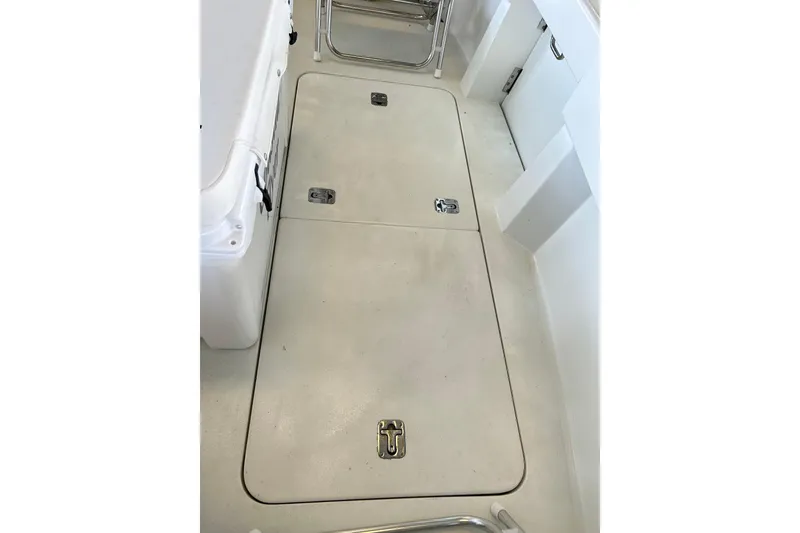 Slide: The Image of 1996 Hatteras 39 Sport Express deck with storage hatches and seating area. - 40