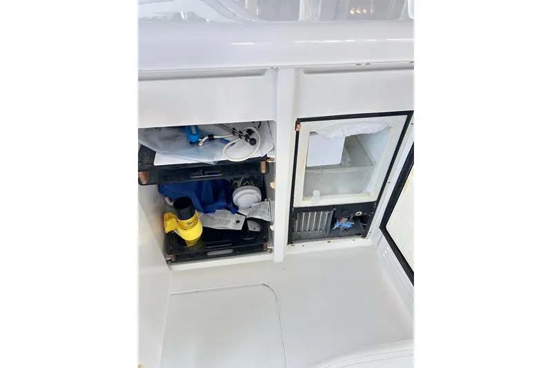 Slide: The Image of Storage compartment and mini fridge on 1996 Hatteras 39 Sport Express boat. - 44