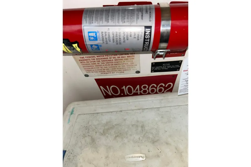 Slide: The Image of Fire extinguisher and safety notices on 1996 Hatteras 39 Sport Express boat. - 45