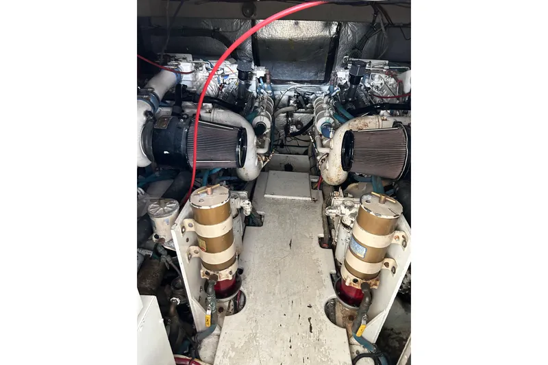 Slide: The Image of Engine room of a 1996 Hatteras 39 Sport Express boat, showcasing dual engines. - 46