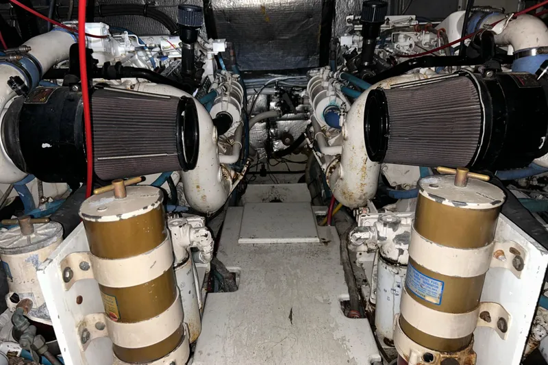 Slide: The Image of Engine room of a 1996 Hatteras 39 Sport Express, showcasing dual engines and components. - 47