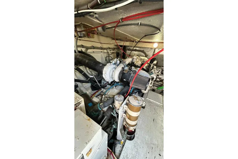 Slide: The Image of Engine room of 1996 Hatteras 39 Sport Express with visible components and wiring. - 48