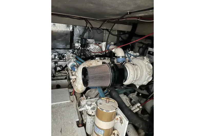 Slide: The Image of Engine room of a 1996 Hatteras 39 Sport Express boat, showcasing mechanical components. - 50