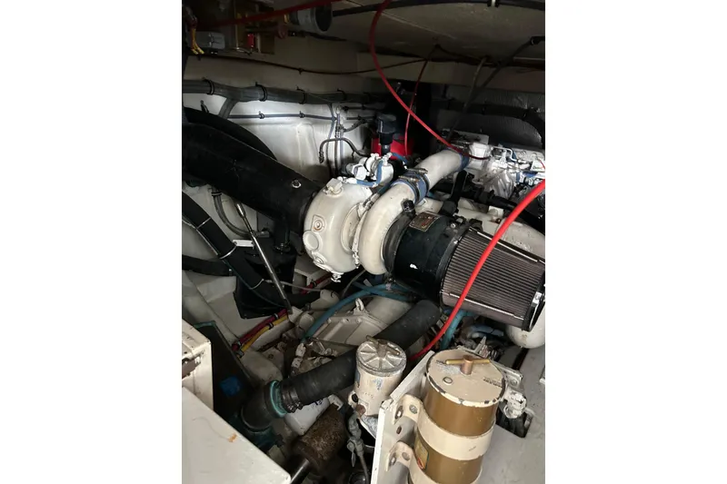 Slide: The Image of Engine room of a 1996 Hatteras 39 Sport Express boat, showcasing mechanical components. - 51