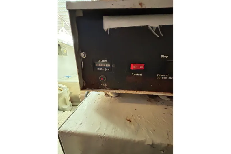 Slide: The Image of Control panel of a 1996 Hatteras 39 Sport Express boat with quartz hour meter. - 54