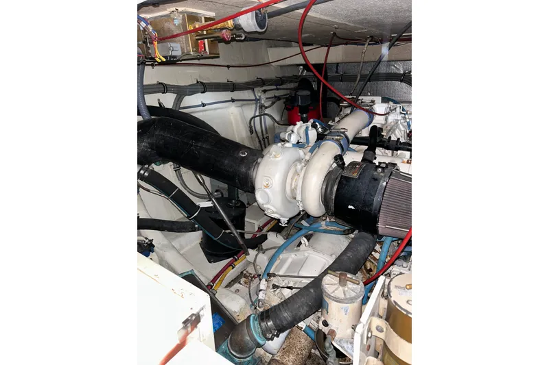 Slide: The Image of Engine compartment of 1996 Hatteras 39 Sport Express with visible components and wiring. - 55