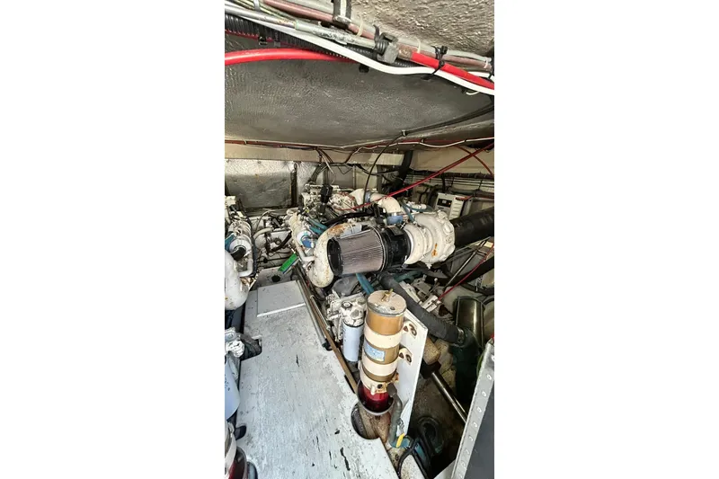 Slide: The Image of Engine room of 1996 Hatteras 39 Sport Express with visible machinery and components. - 56