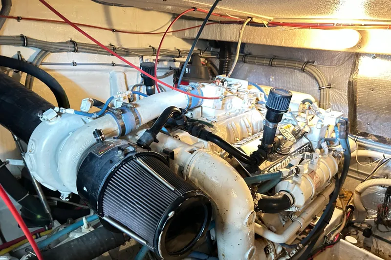 Slide: The Image of Engine room of a 1996 Hatteras 39 Sport Express, showcasing detailed mechanical components. - 58