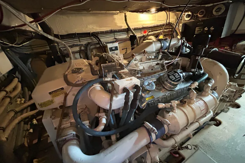Slide: The Image of Engine room of a 1996 Hatteras 39 Sport Express, showcasing detailed machinery and components. - 59