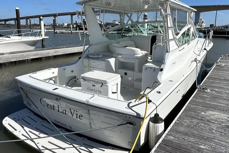 Slide: The Image of 1996 Hatteras 39 Sport Express docked, featuring spacious deck and sleek design. - 6