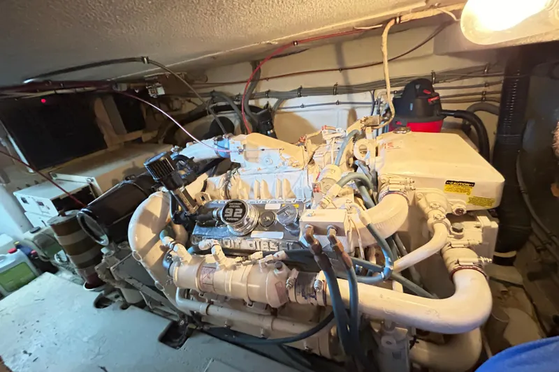 Slide: The Image of Engine room of 1996 Hatteras 39 Sport Express with visible diesel engine components. - 61