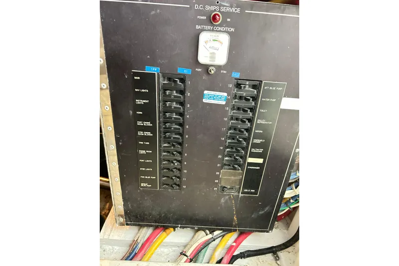 Slide: The Image of Electrical panel on a 1996 Hatteras 39 Sport Express boat, showing switches and wiring. - 62