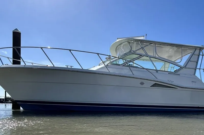 Slide: The Image of 1996 Hatteras 39 Sport Express boat docked under clear blue sky. - 9