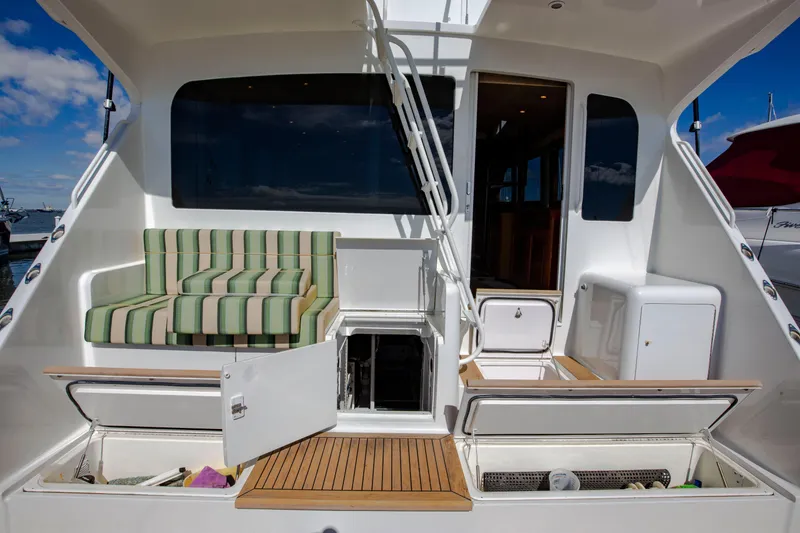 Slide: The Image of 2002 Viking 65 Enclosed Bridge yacht with striped seating and open storage compartments. - 17