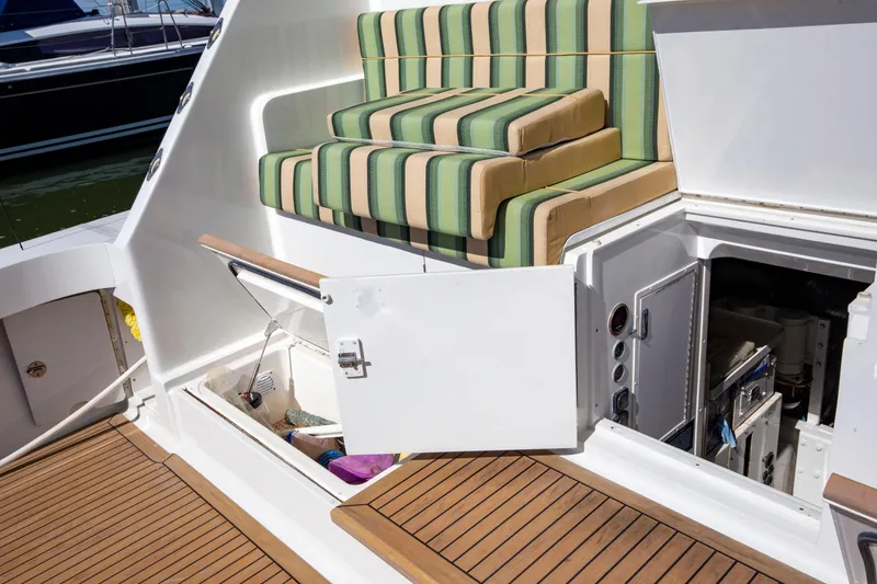 Slide: The Image of 2002 Viking 65 Enclosed Bridge yacht with striped seating and open storage compartments. - 18