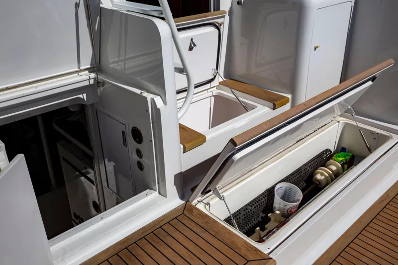 Slide: The Image of 2002 Viking 65 Enclosed Bridge yacht deck with open storage compartments. - 19