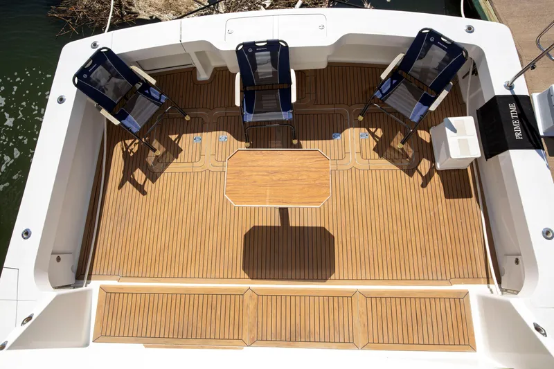 Slide: The Image of 2002 Viking 65 Enclosed Bridge yacht deck with chairs and table. - 22