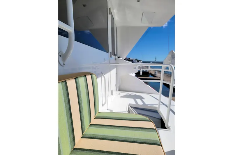 Slide: The Image of Striped seating on 2002 Viking 65 Enclosed Bridge yacht deck, with ocean view. - 24