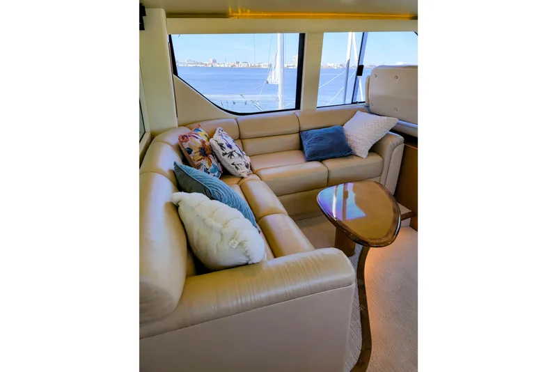 Slide: The Image of Luxurious interior of 2002 Viking 65 Enclosed Bridge yacht with plush seating and scenic view. - 26