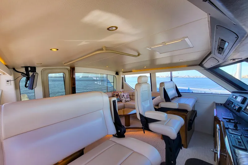 Slide: The Image of Luxurious interior of 2002 Viking 65 Enclosed Bridge yacht with panoramic ocean views. - 29