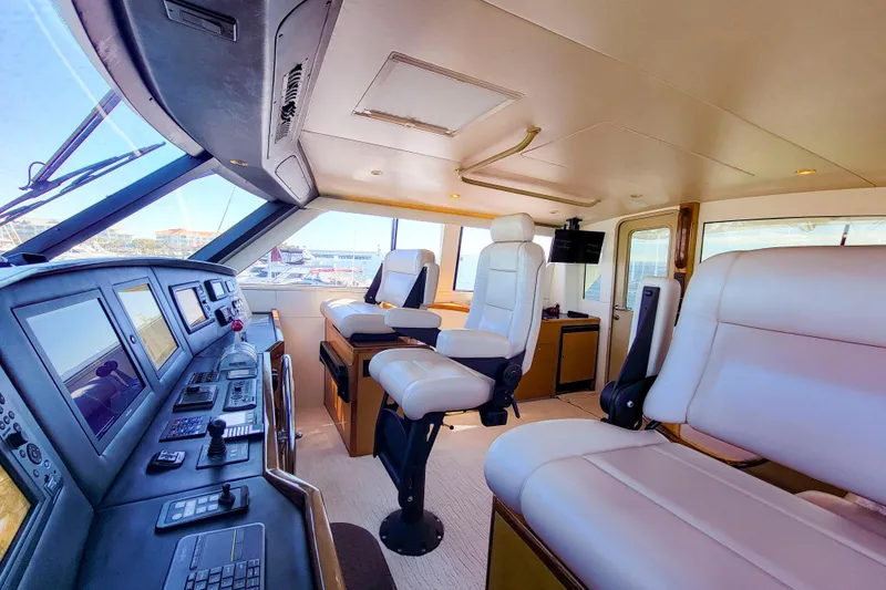 Slide: The Image of Luxurious interior of 2002 Viking 65 Enclosed Bridge yacht with modern navigation controls. - 30