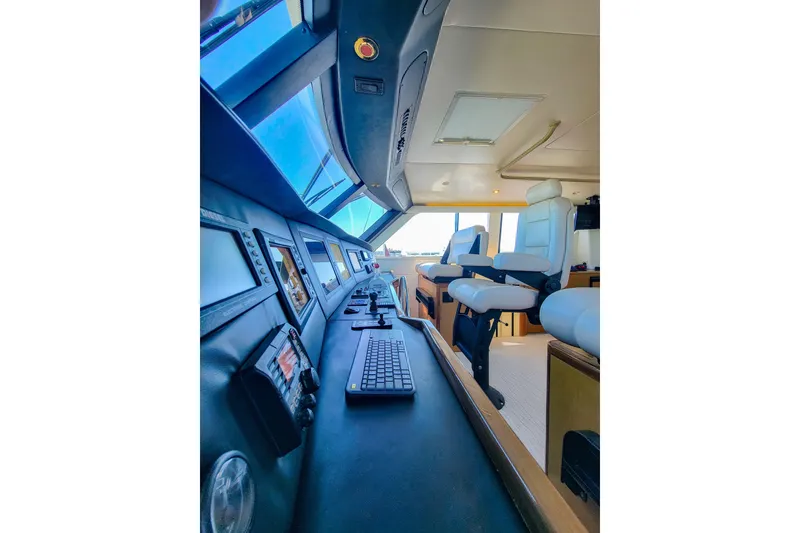 Slide: The Image of Interior view of 2002 Viking 65 Enclosed Bridge yacht cockpit with modern controls. - 31