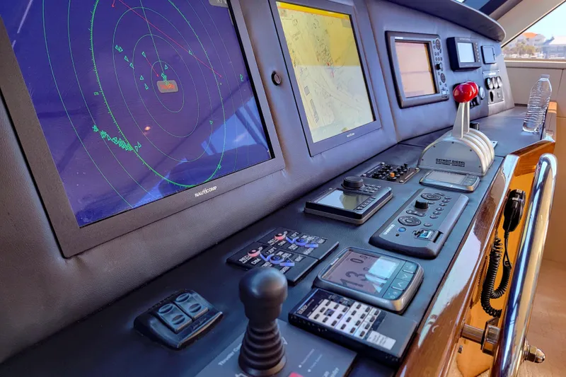 Slide: The Image of Control panel of a 2002 Viking 65 Enclosed Bridge yacht with navigation screens. - 33