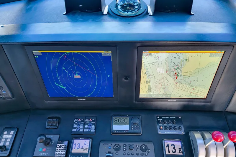 Slide: The Image of Navigation system of a 2002 Viking 65 Enclosed Bridge yacht, featuring radar and map displays. - 34