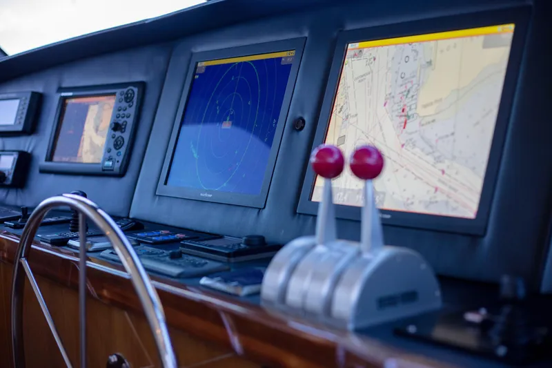 Slide: The Image of Control panel of 2002 Viking 65 Enclosed Bridge yacht with navigation screens. - 39