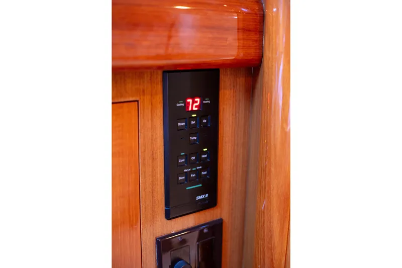 Slide: The Image of Control panel on 2002 Viking 65 Enclosed Bridge yacht, displaying temperature settings. - 48