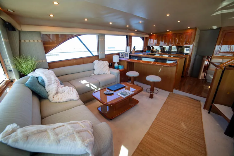 Slide: The Image of Luxurious interior of 2002 Viking 65 Enclosed Bridge yacht with elegant seating and modern kitchen. - 53