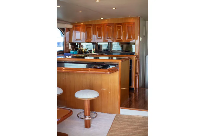 Slide: The Image of Luxurious interior of 2002 Viking 65 Enclosed Bridge yacht with polished wood cabinetry. - 58