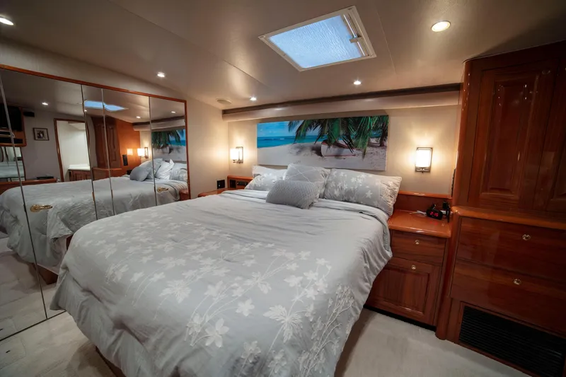 Slide: The Image of Luxurious bedroom interior of 2002 Viking 65 Enclosed Bridge yacht with elegant wood finishes. - 67