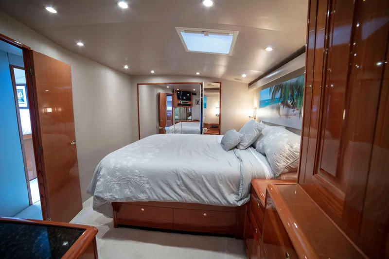 Slide: The Image of Luxurious bedroom interior of 2002 Viking 65 Enclosed Bridge yacht with elegant wood finishes. - 70