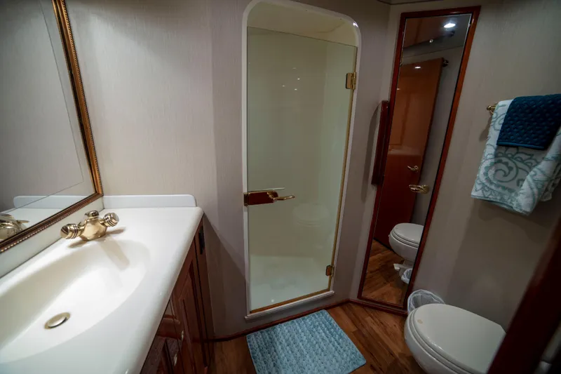 Slide: The Image of Luxurious bathroom in 2002 Viking 65 Enclosed Bridge yacht with shower and elegant fixtures. - 71