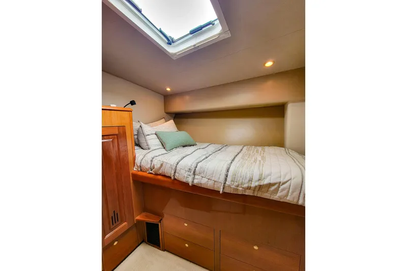Slide: The Image of Cozy cabin interior of 2002 Viking 65 Enclosed Bridge yacht with skylight and bedding. - 79